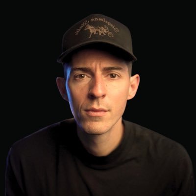 Kane Kallaway wearing a black cap against a dark background